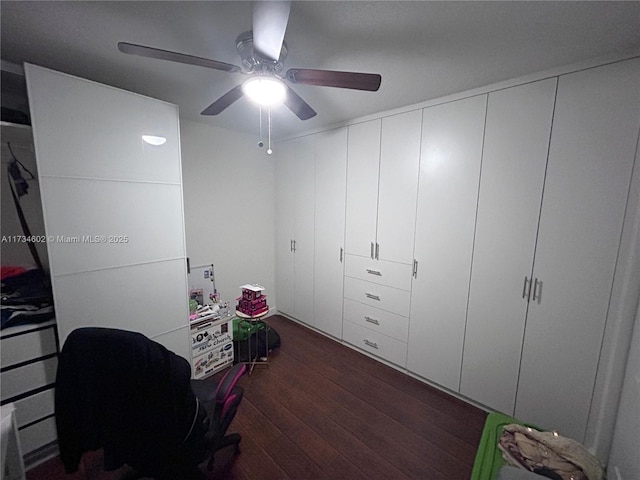 interior space with dark wood-type flooring and ceiling fan