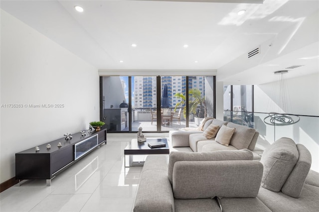 living room featuring light tile patterned floors and a wall of windows