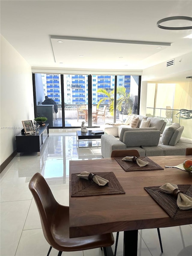 living room featuring expansive windows and light tile patterned floors