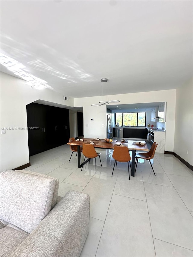 tiled living room featuring sink