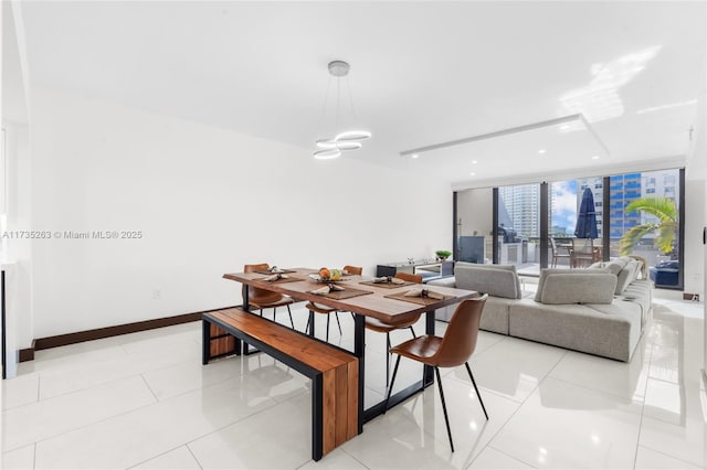 dining room with light tile patterned floors and a wall of windows