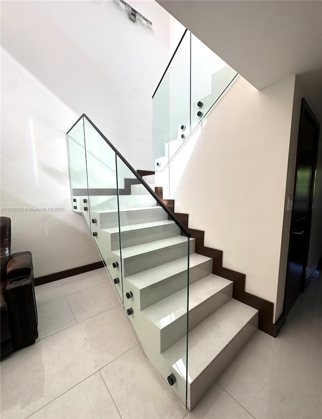 stairs with tile patterned flooring