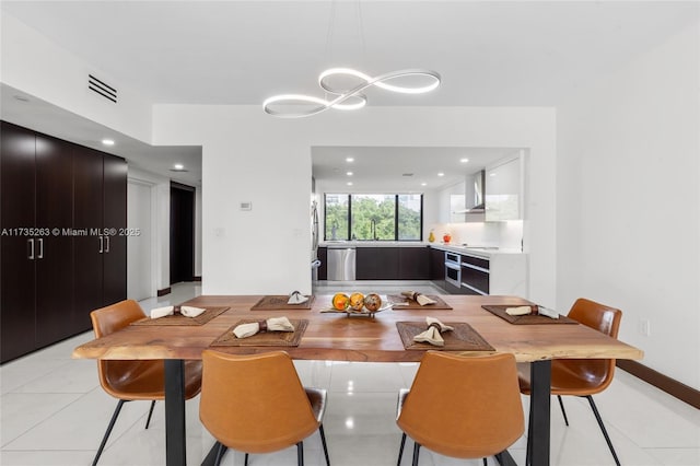 dining room with light tile patterned floors and an inviting chandelier