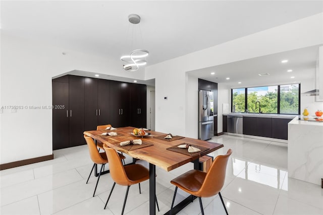 tiled dining space featuring sink