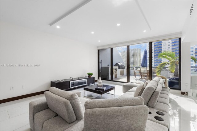 living room with expansive windows and light tile patterned floors