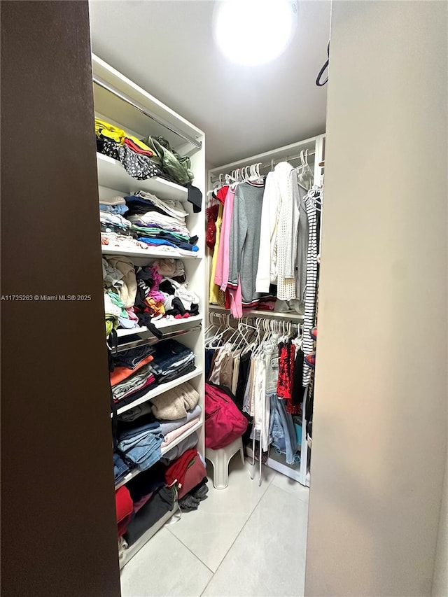 spacious closet with light tile patterned flooring