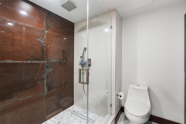 bathroom with toilet and a shower with shower door