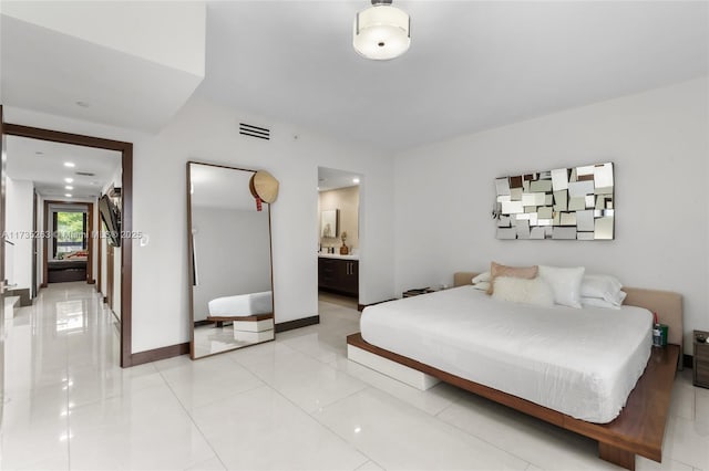 tiled bedroom featuring ensuite bath