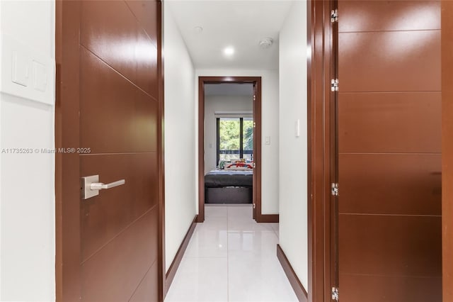 corridor with light tile patterned flooring