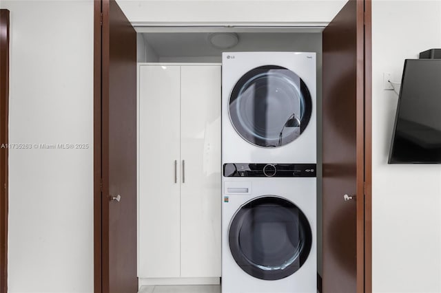 laundry area featuring stacked washer / drying machine