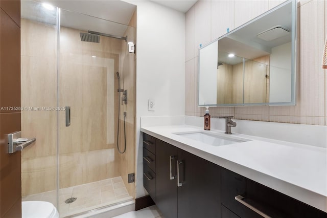 bathroom featuring vanity and a shower with shower door