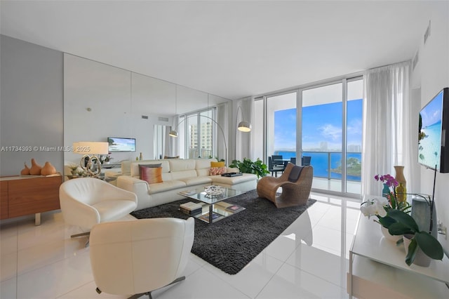 tiled living room featuring a wall of windows