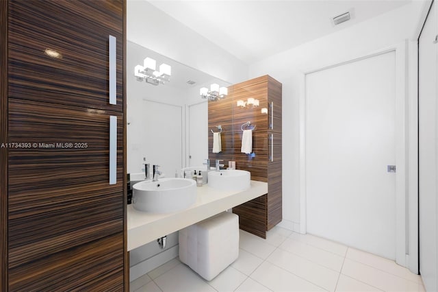 bathroom featuring tile patterned floors, vanity, and a notable chandelier