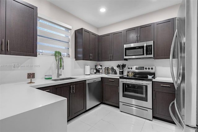 kitchen featuring stainless steel appliances, kitchen peninsula, sink, and dark brown cabinets