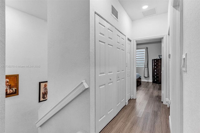 corridor with hardwood / wood-style floors