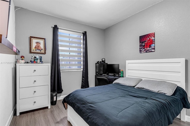 bedroom with light hardwood / wood-style floors