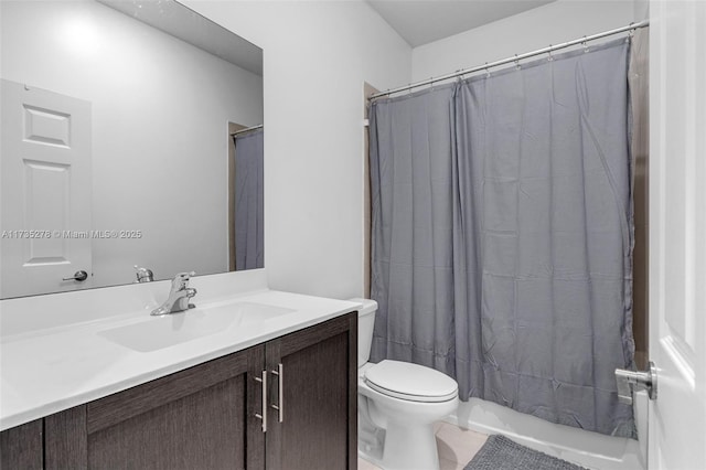 full bathroom with vanity, shower / tub combo, and toilet