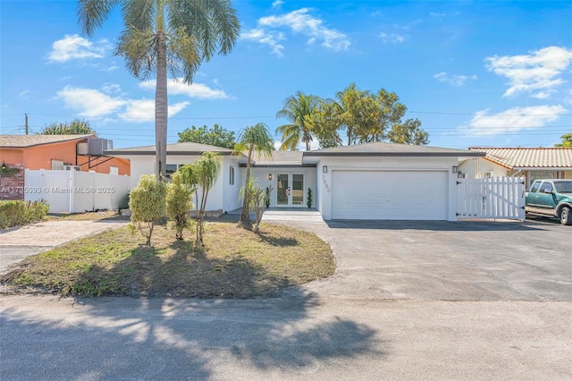 single story home with central AC and a garage