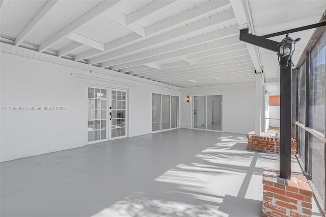 sunroom featuring french doors and beam ceiling