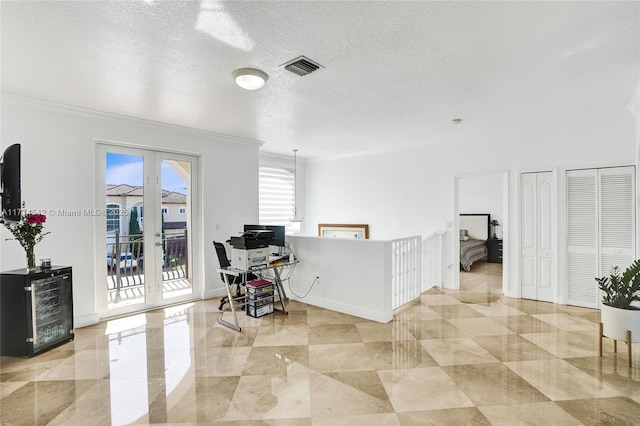 home office featuring ornamental molding, french doors, a textured ceiling, and beverage cooler