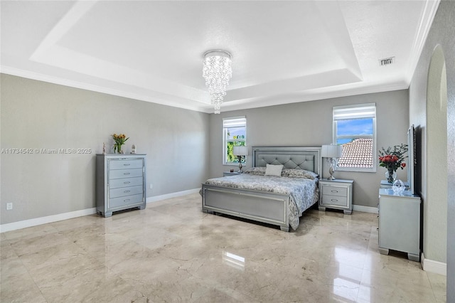 bedroom featuring a chandelier, ornamental molding, and a raised ceiling