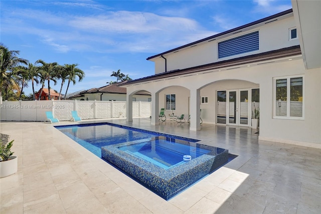 view of swimming pool featuring an in ground hot tub and a patio