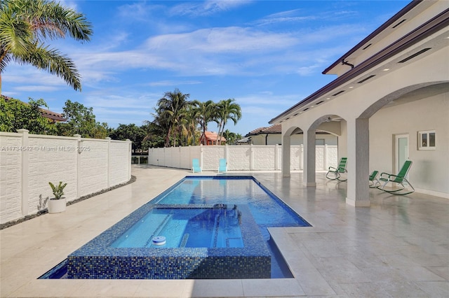 view of swimming pool featuring a patio area and an in ground hot tub