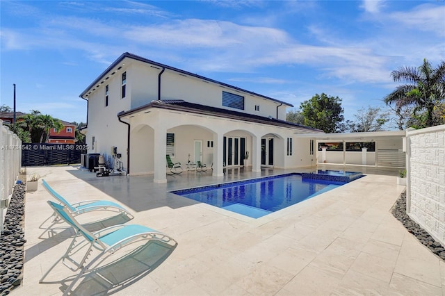 view of pool with an in ground hot tub, central AC, and a patio area