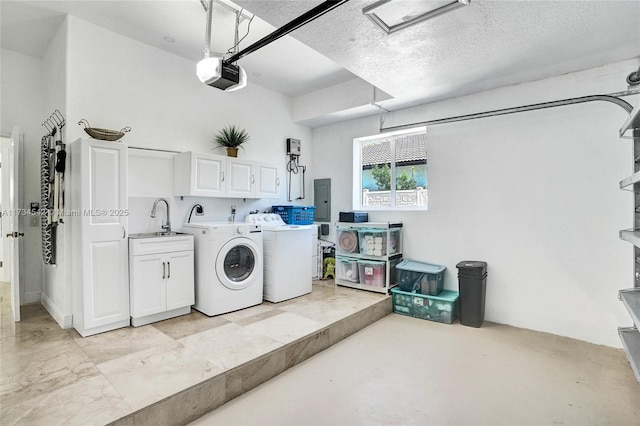 washroom with sink, cabinets, washer and clothes dryer, electric panel, and a textured ceiling