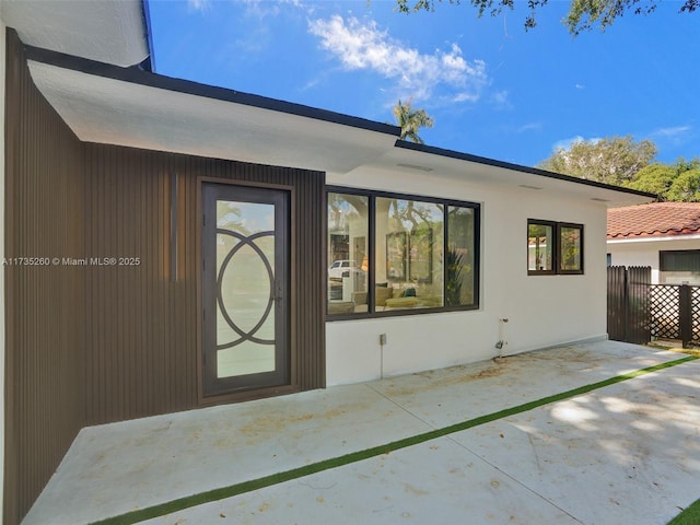 property entrance featuring a patio