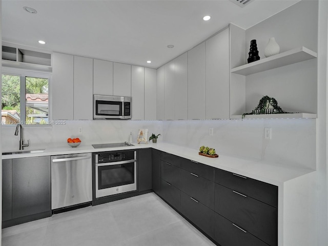 kitchen featuring white cabinetry, sink, tasteful backsplash, and stainless steel appliances