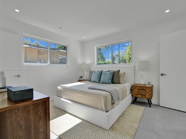 bedroom featuring multiple windows and light tile patterned floors