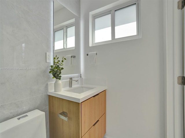 bathroom featuring vanity and toilet