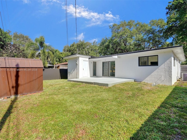 rear view of house featuring a yard, a patio area, and central air condition unit