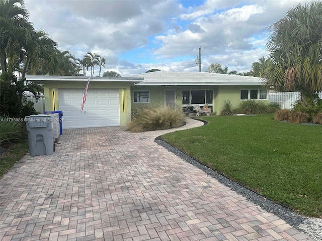 ranch-style house with a garage and a front yard