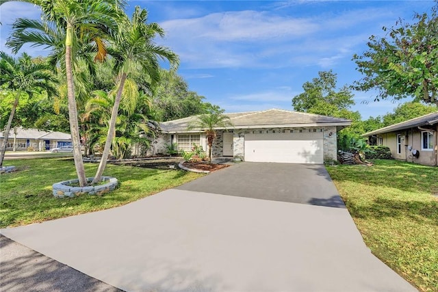 single story home featuring a garage and a front lawn