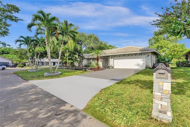 ranch-style house featuring a garage and a front lawn