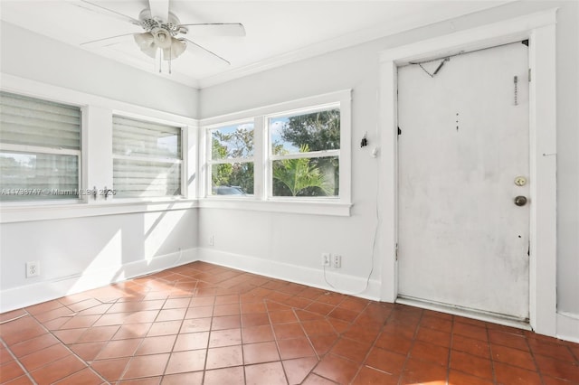 entrance foyer featuring tile patterned flooring, ornamental molding, and ceiling fan