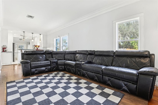 living room featuring dark wood-type flooring and ornamental molding