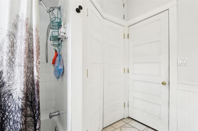 bathroom with shower / bathtub combination with curtain and tile patterned flooring