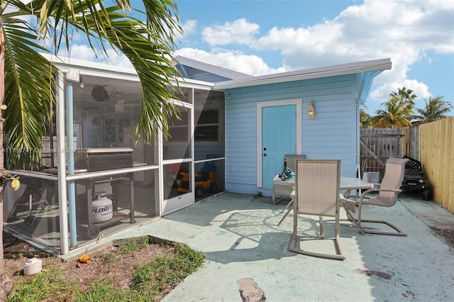 rear view of house with a patio and a sunroom