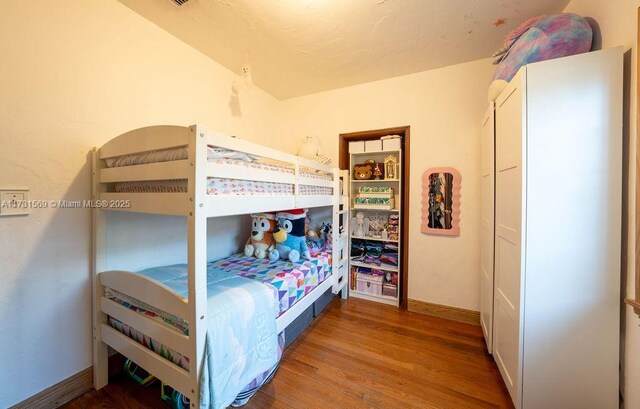 bedroom with wood-type flooring