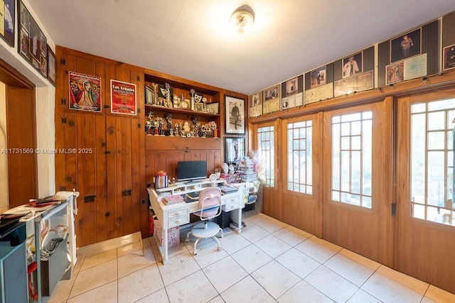 tiled office space featuring wood walls