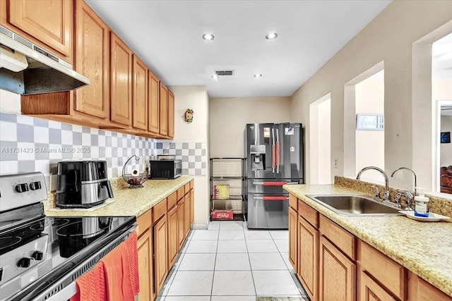 kitchen featuring tasteful backsplash, sink, light tile patterned floors, and stainless steel appliances