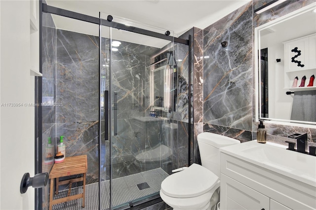 bathroom featuring a shower with shower door, tile walls, decorative backsplash, vanity, and toilet