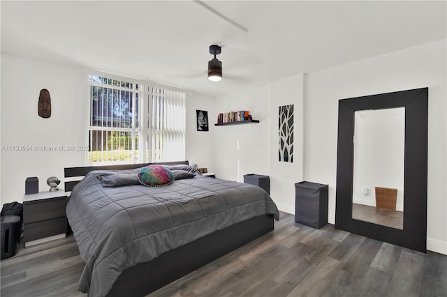 bedroom with dark wood-type flooring and ceiling fan