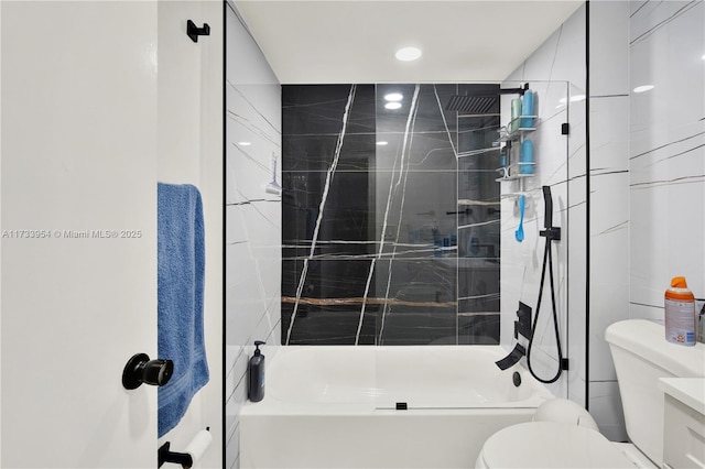 bathroom with tile walls, toilet, and tiled shower