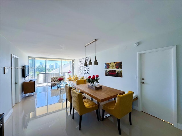 dining room with floor to ceiling windows and light tile patterned flooring