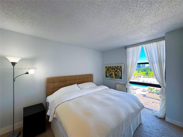 carpeted bedroom with a textured ceiling