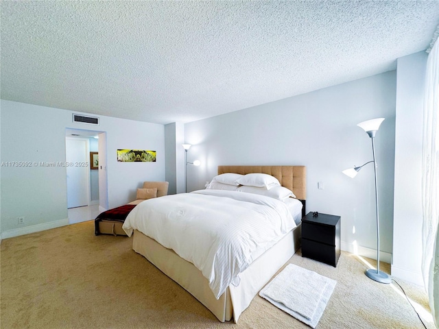 carpeted bedroom featuring a textured ceiling